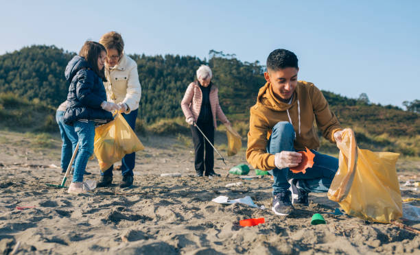 istock Young man cleaning the beach 1149083741