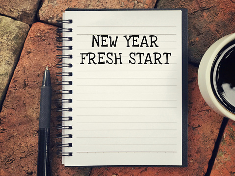 New Year, Fresh Start written on a notebook.