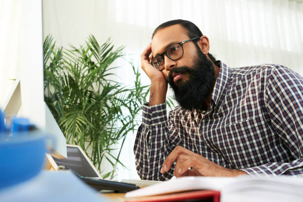 istock Exhausted businessman working at office 1149085334