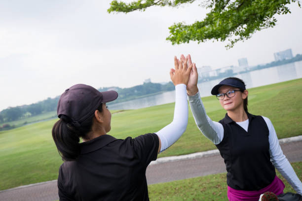 istock Female golfers celebrating the game with a high five 1149086441