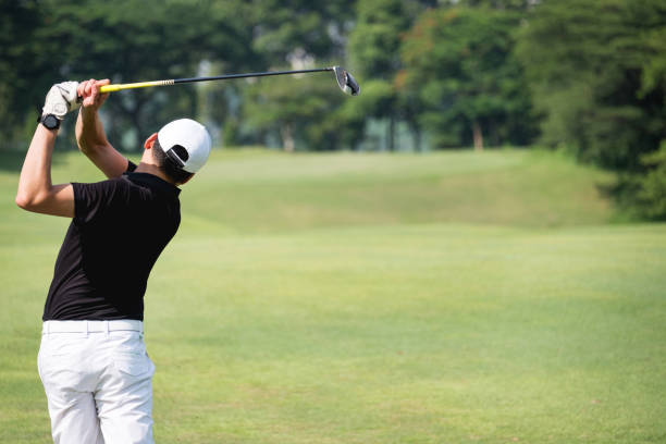 istock Rear view of man teeing off on golf course 1149086519