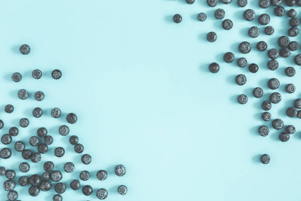 istock Blueberry on blue background. Flat lay, top view 1149087922