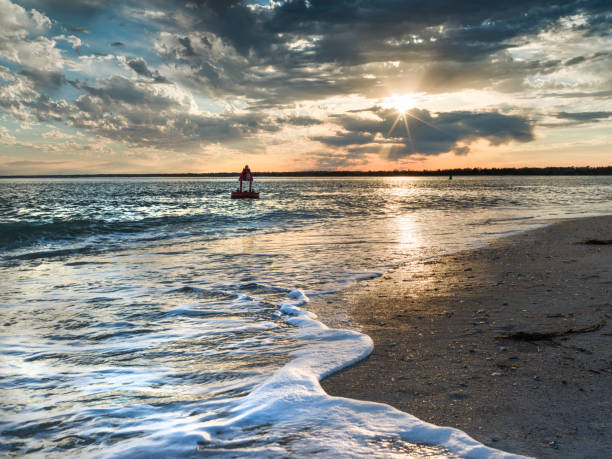 Sunset at Wrightsville Beach North Carolina with a buoy floating in the water
