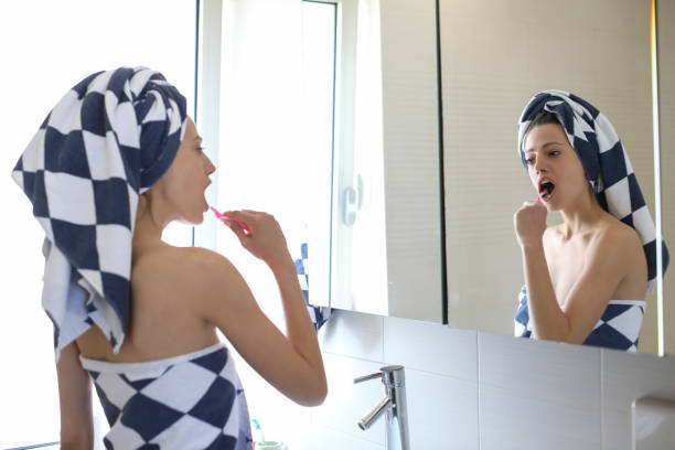 istock Young woman washing her teeth 1149089056