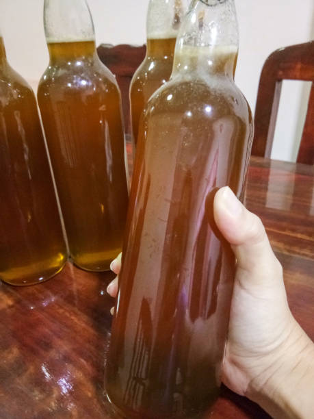 istock Fresh honey in glass bottle on hand 1149089135