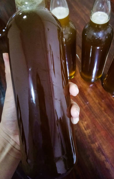 istock Fresh honey in glass bottle on hand 1149089164