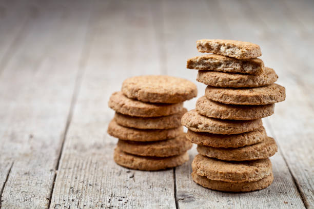 istock Two stacks of fresh baked oat cookies on rustic wooden table background. 1149089601
