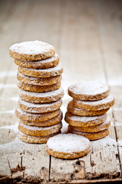 istock Fresh oat cookies stacks with sugar powder closeup on rustic wooden table. 1149089745