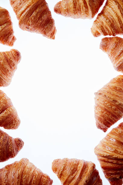 istock French croissants frame with copy space on a white background. 1149091195
