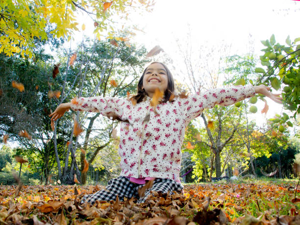 istock Girl throwing leaves 1149092637