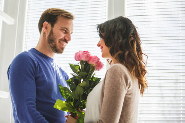 istock Smiling man and woman with roses 1149093762