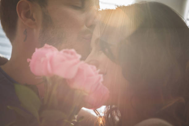 istock Smiling man and woman with roses 1149093764