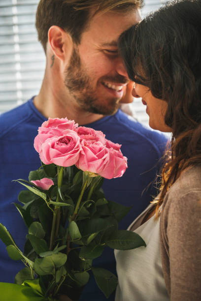 istock Smiling couple with roses 1149093771