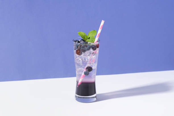 istock Cold and refreshing  blueberry punch cocktail with mint on purple background. summer drink 1149098780