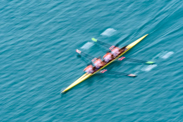 quadruple scull rowing team practicing, blurred motion - rowboat sport rowing team sports race imagens e fotografias de stock