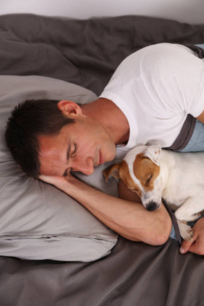 istock Man and dog sleeping together. Pet Allergies concept 1149100940