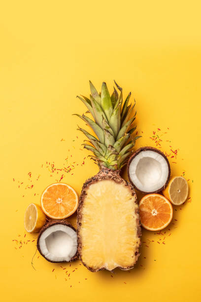 istock Tropical fruit flat lay with pineapple, oranges, lemon and coconut on a pastel background. 1149101230