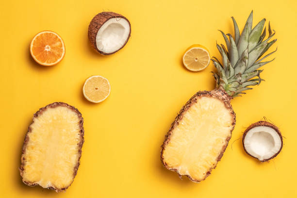 istock Tropical pineapple, oranges, lemon and coconut on a pastel background. 1149101245