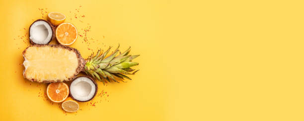 istock Tropical fruit flat lay with pineapple, oranges, lemon and coconut on a pastel background. 1149101274