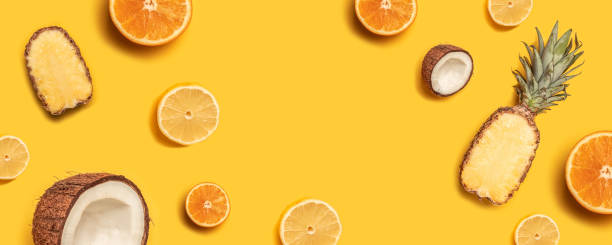 istock Tropical fruit flat lay with pineapple, oranges, lemon and coconut on a pastel background. 1149102430