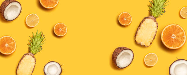 istock Tropical fruit flat lay with pineapple, oranges, lemon and coconut on a pastel background. 1149102438
