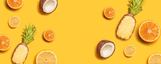 istock Tropical fruit flat lay with pineapple, oranges, lemon and coconut on a pastel background. 1149102447