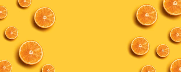 istock Fruit pattern of fresh orange slices on yellow background. 1149102473