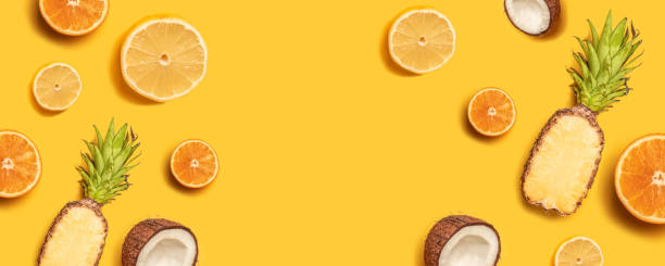istock Tropical fruit flat lay with pineapple, oranges, lemon and coconut on a pastel background. 1149102485