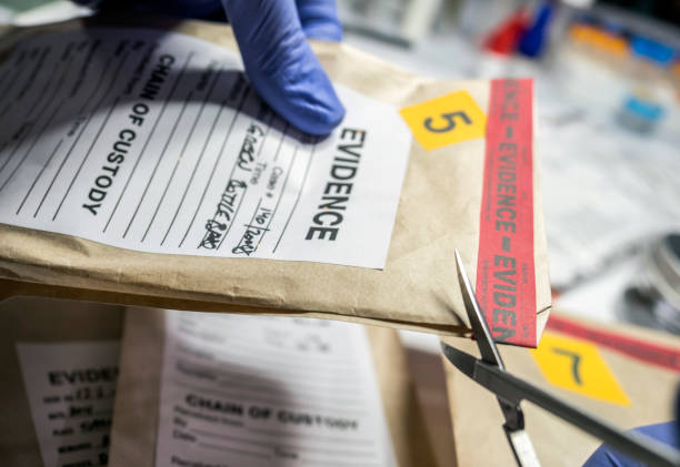 wissenschaftliche polizei öffnet mit schere eine tasche mit beweisen für eine straftat in wissenschaftlichem labor - csi stock-fotos und bilder