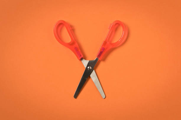 istock Scissors on an orange background. Colored baby scissors. 1149105902