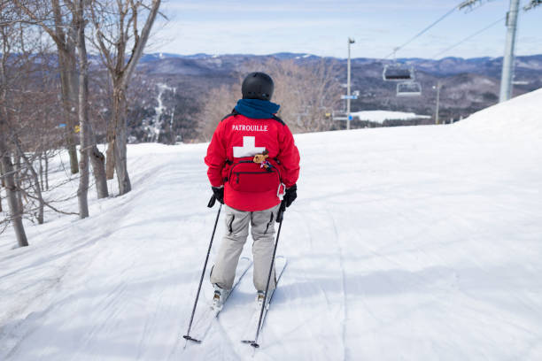 First aid ski patrol with backpacks Security in mountain ski patrol photos stock pictures, royalty-free photos & images