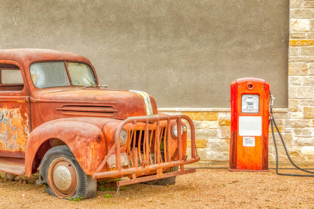 Rusty car at a gas pump