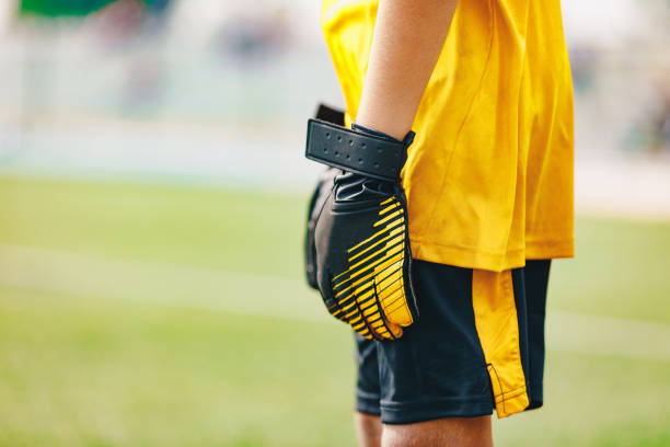 close up of soccer gloves of young boy soccer goalie standing in a goal - soccer glove imagens e fotografias de stock