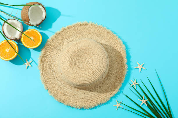 istock Straw hat, oranges, coconuts, palm leaves and starfishes on color background, space for text and top view. Summer vacation backdrop 1149106079