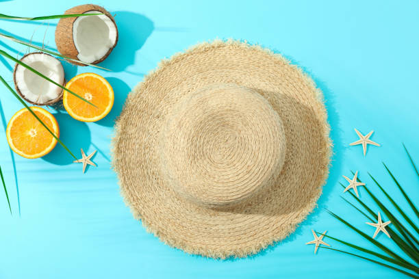 istock Straw hat, oranges, coconuts, palm leaves and starfishes on color background, space for text and top view. Summer vacation backdrop 1149106385