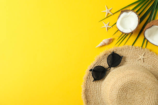 istock Straw hat, sunglasses, starfishes, coconuts and palm leaf on color background space for text and top view. Summer vacation backdrop 1149106432