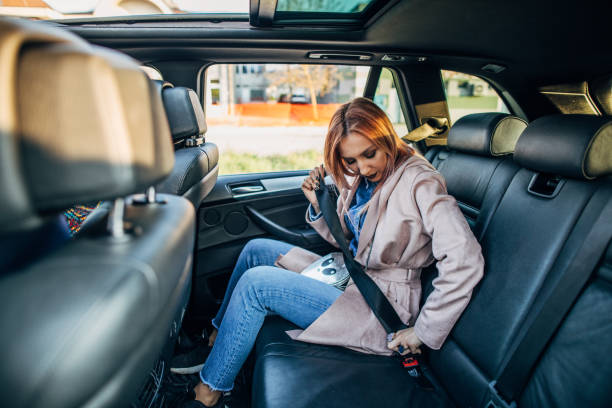 istock Woman putting seat belt on 1149107466