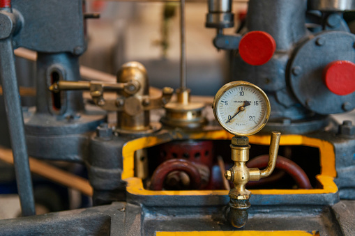 Vintage brass machinery with manometer. Steampunk background