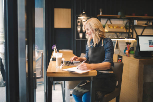istock Coffee shop owner working on laptop 1149108538