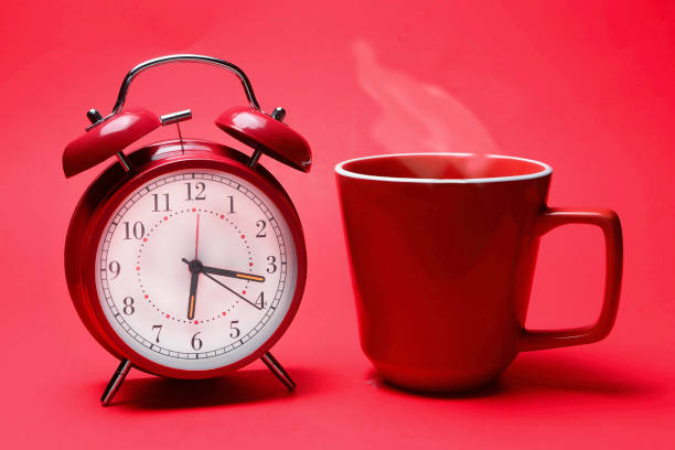 istock Delicious morning beverage with red alarm clock . 1149109129
