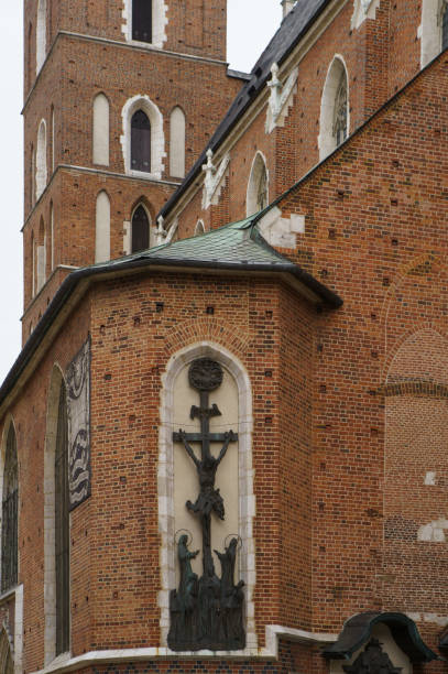 KRAKOW,POLAND-23 APRIL,2019: Crucifixion monument on catholic church exterior in old historic center of Polish city Krakow.Christian symbol on ancient temple wall