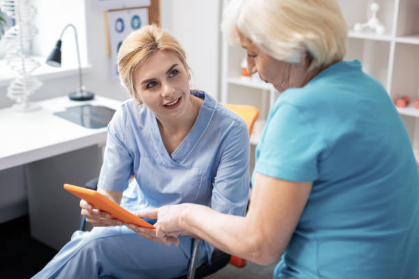 Pleasant aged woman pointing at the tablet screen