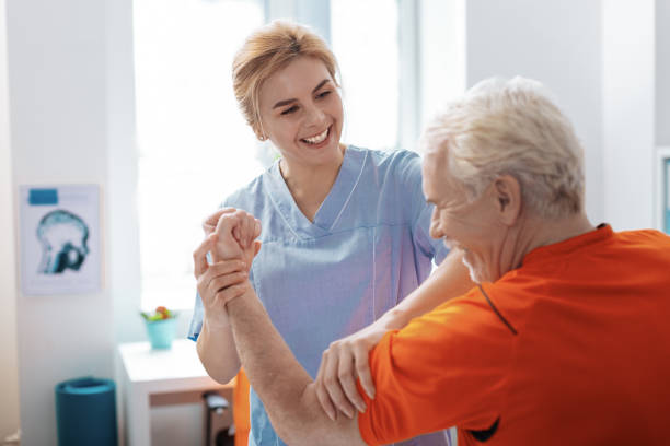istock Joyful positive nurse smiling to her patient 1149110137