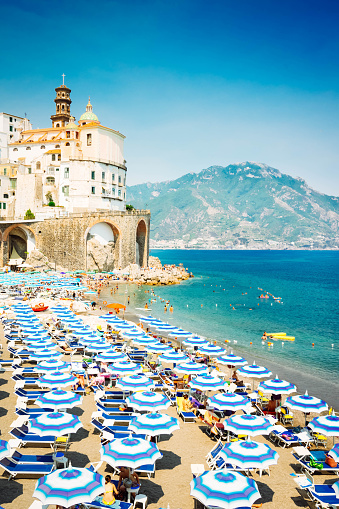 Amalfi town and summer Atrani beach with umbrellas , Italy, retro toned