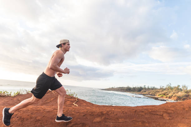 istock Shirtless jogger running along the wild Hawaii coastline 1149110919