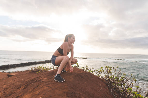 istock Female jogger taking a break from running along the Hawaii coastline 1149110926