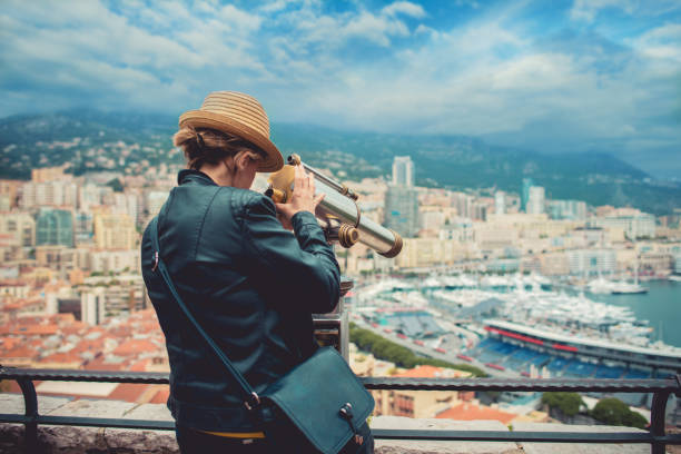 Tourist looking through telescope in Monaco