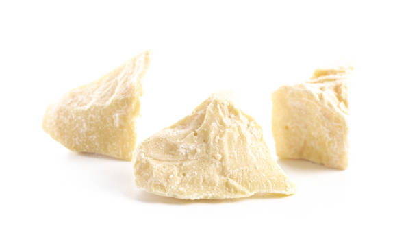 Chunks of Raw Organic Cocoa Butter Isolated on a White Background Chunks of Raw Organic Cocoa Butter Isolated on a White Background chocolate white chocolate chocolate chip white stock pictures, royalty-free photos & images