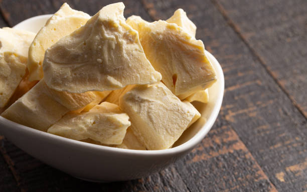 Chunks of Raw Organic Cocoa Butter on a Wooden Table Chunks of Raw Organic Cocoa Butter on a Wooden Table chocolate white chocolate chocolate chip white stock pictures, royalty-free photos & images