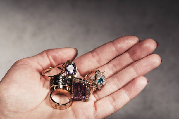istock Different gold rings in hand close up. Precious metal scrap 1149111752